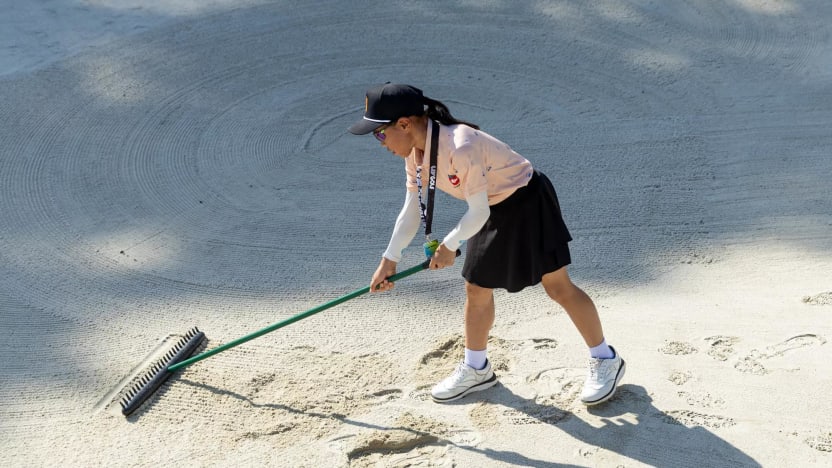 The junior golfers rake the bunker on the tenth green during the green up initiative before the start of LIV Golf Singapore at Sentosa Golf Club on Wednesday, May 01, 2024 in Sentosa, Singapore. (Photo by Jon Ferrey/LIV Golf)