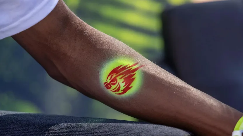 A fan gets a temporary tattoo in the Fan Village during the second round of LIV Golf Miami at the Trump National Doral on Saturday, April 06, 2024 in Miami, Florida. (Photo by Scott Taetsch/LIV Golf)