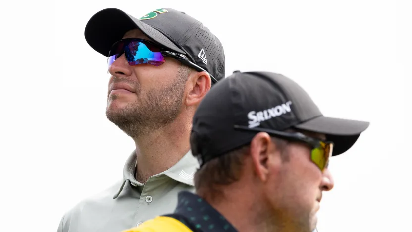 Dean Burmester of Stinger GC and caddie, Jason Reynolds, are seen on the 10th tee during the second round of the 2025 PGA Championship at Quail Hollow Club on Friday, May 16, 2025 in Charlotte, North Carolina. (Photo by Jon Ferrey/LIV Golf)