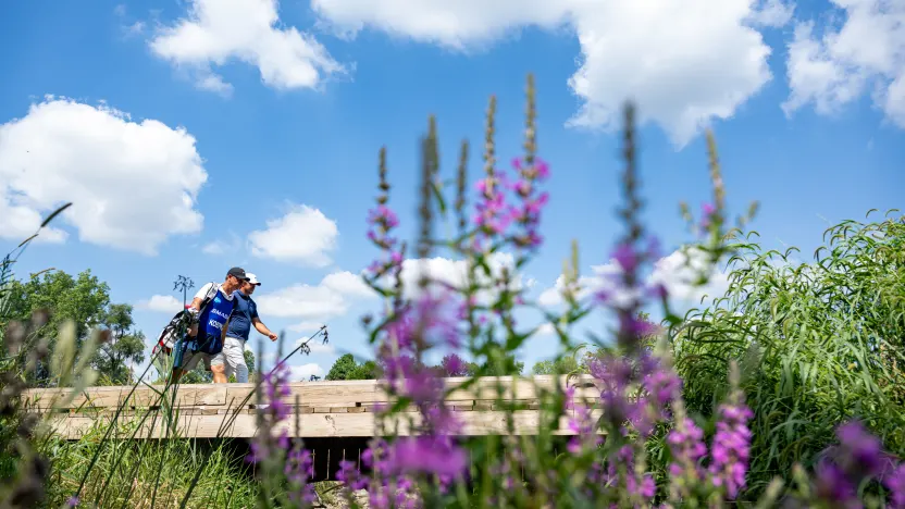 Captain Brooks Koepka of Smash GC and his caddie, Ricky Elliot, walk along the sixth hole during the quarterfinals of LIV Golf Team Championship Michigan at The Cardinal at Saint John’s on Friday, August 22, 2025 in Plymouth, MIchigan. (Photo by Charles Laberge/LIV Golf)