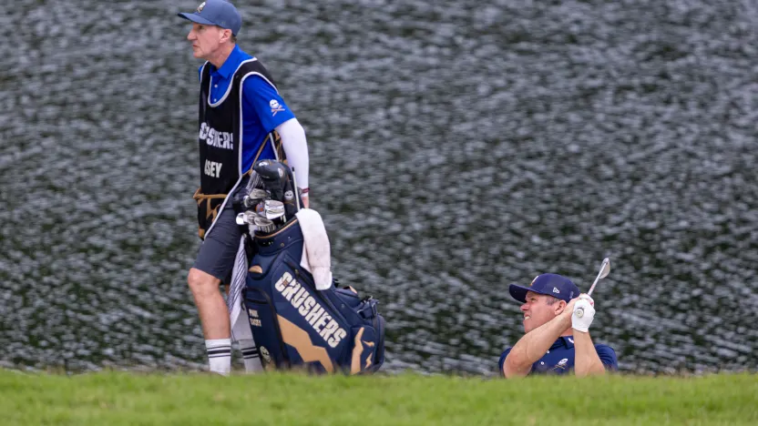 Paul Casey of Crushers GC hits his shot on the ninth hole as his caddie, John McLaren, watches during the final round of LIV Golf Singapore at Sentosa Golf Club on Sunday, March 16, 2025 in Sentosa, Singapore. (Photo by Jon Ferrey/LIV Golf)