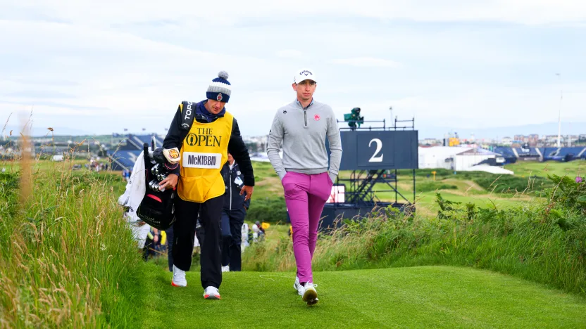 Tom McKibbin of Legion XIII walks on the second hole with his caddie, Ricky McCormick, during the first round of The Open Championship at Royal Portrush Golf Club on Thursday, July 17, 2025 in Portrush, Northern Ireland. (Photo by Chris Trotman/LIV Golf)