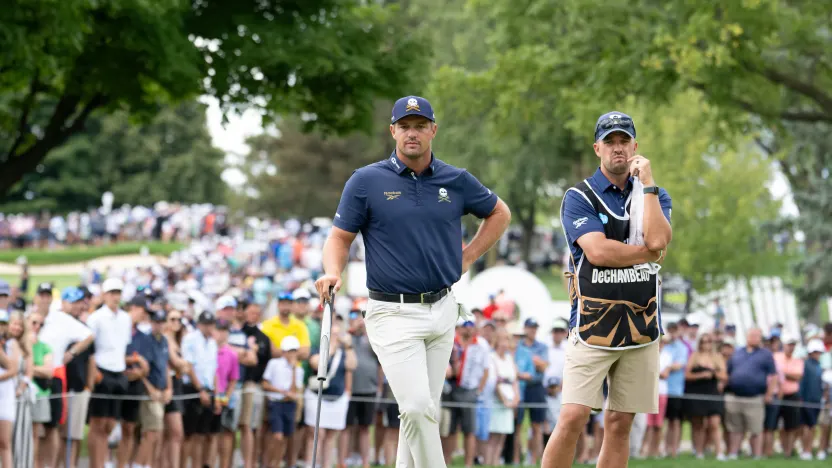 Captain Bryson DeChambeau of Crushers GC and caddie, Greg Bodine are seen on the first green during the final round of LIV Golf Team Championship Michigan at The Cardinal at Saint John’s on Sunday, August 24, 2025 in Plymouth, MIchigan. (Photo by Charles Laberge/LIV Golf)