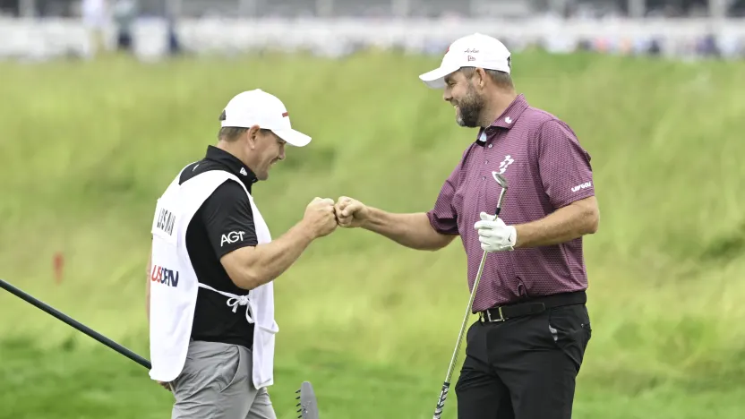 Marc Leishman of Ripper GC and caddie, Matthew Kelly, fist bump on the eighth green during the third round of the US Open at Oakmont Country Club on Saturday, June 14, 2025 in Oakmont, Pennsylvania. (Photo by Charles Laberge/LIV Golf)