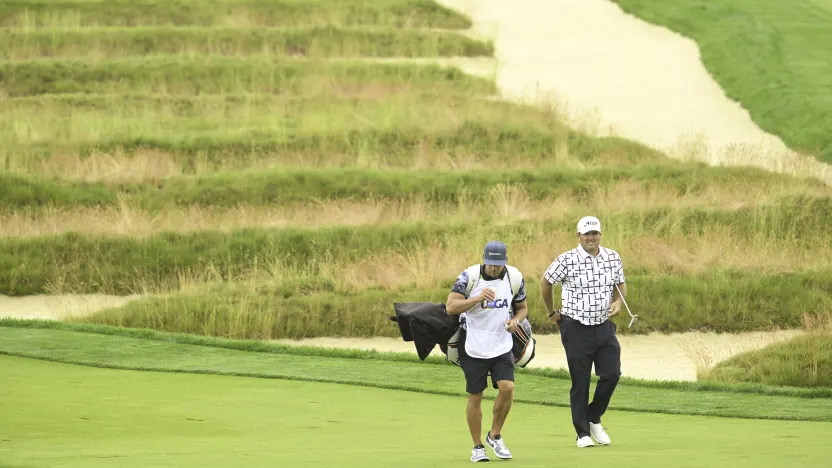 Patrick Reed of 4Aces GC and caddie, Kessler Karain, on the third hole during the third round of the US Open at Oakmont Country Club on Saturday, June 14, 2025 in Oakmont, Pennsylvania. (Photo by Charles Laberge/LIV Golf)