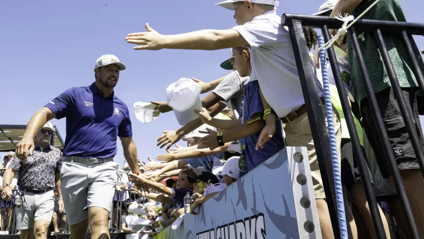 Captain Bryson DeChambeau of Crushers GC high-fives Little Sharks during the first round of LIV Golf Dallas at Maridoe Golf Club on Friday, June 27, 2025 in Carrollton, Texas. (Photo by Oliver Brady/LIV Golf)