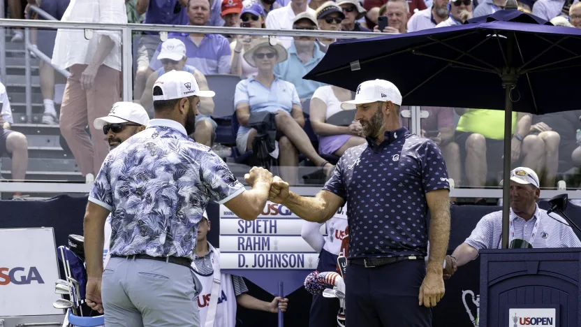 Captain Jon Rahm of Legion XIII and Captain Dustin Johnson of 4Aces GC fist bump during the first round of the US Open at Oakmont Country Club on Thursday, June 12, 2025 in Oakmont, Pennsylvania. (Photo by Charles Laberge/LIV Golf)