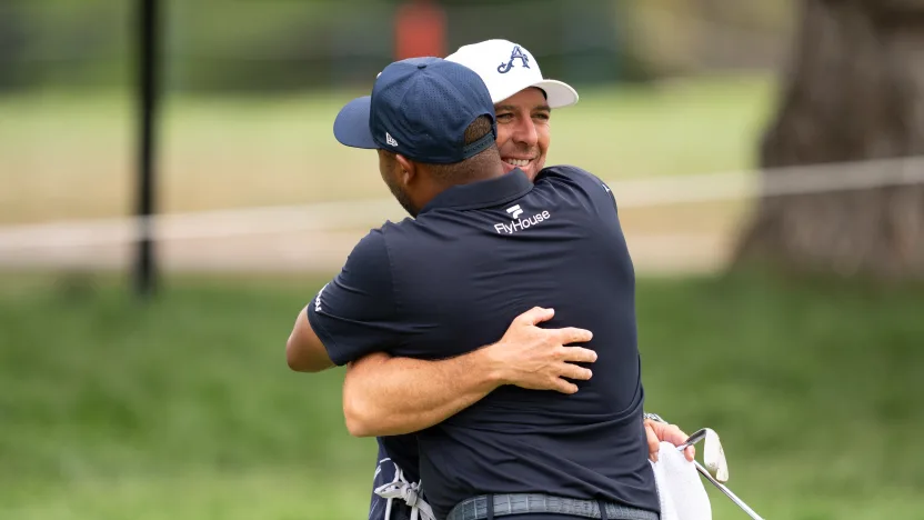 Harold Varner III of 4Aces GC and caddie, Chris Rice hug on the 17th hole during the semifinals of LIV Golf Team Championship Michigan at The Cardinal at Saint John’s on Saturday, August 23, 2025 in Plymouth, MIchigan. (Photo by Mateo Villalba/LIV Golf)