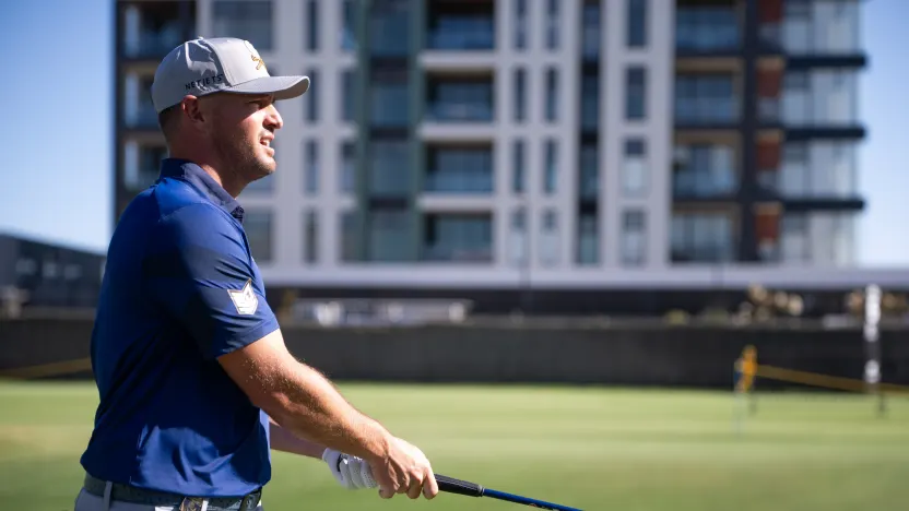 Captain Bryson DeChambeau of Crushers GC watches his shot from the fourth fairway during the practice round before the start of LIV Golf Adelaide at Grange Golf Club on Tuesday, February 11, 2025 in Adelaide, Australia. (Photo by Pedro Salado/LIV Golf)