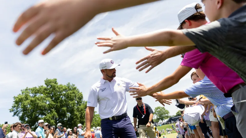 Captain Bryson DeChambeau of Crushers GC high fives fans during the third round of the 2025 PGA Championship at Quail Hollow Club on Saturday, May 17, 2025 in Charlotte, North Carolina. (Photo by Jon Ferrey/LIV Golf)