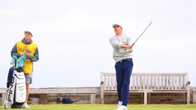 Caddie, Michael Kerr, watches as Carlos Ortiz of Torque GC hits his shot from the sixth tee during the second round of The Open Championship at Royal Portrush Golf Club on Friday, July 18, 2025 in Portrush, Northern Ireland. (Photo by Chris Trotman/LIV Golf)