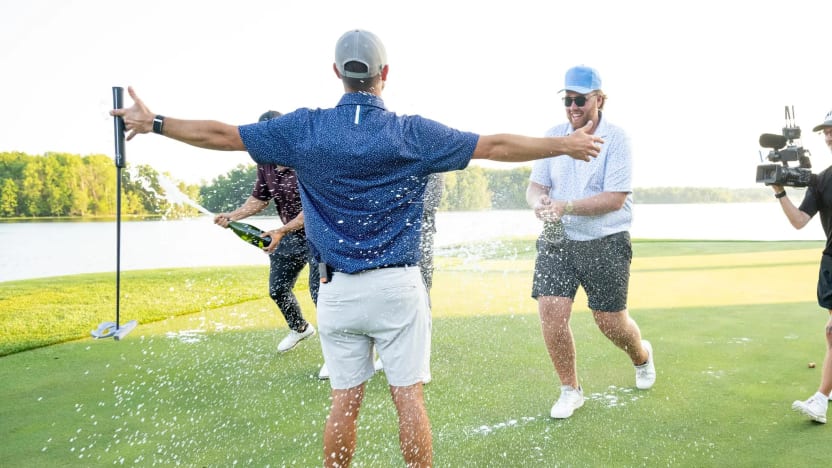 Announcer, Mason Nutt sprays champaign on content creator, Wesley Bryan on the 18th green after his win during the Duels Virginia before the start of LIV Golf Virginia at Robert Trent Jones Golf Club on Tuesday, June 03, 2025 in Gainesville, Virginia. (Photo by Charles Laberge/LIV Golf)