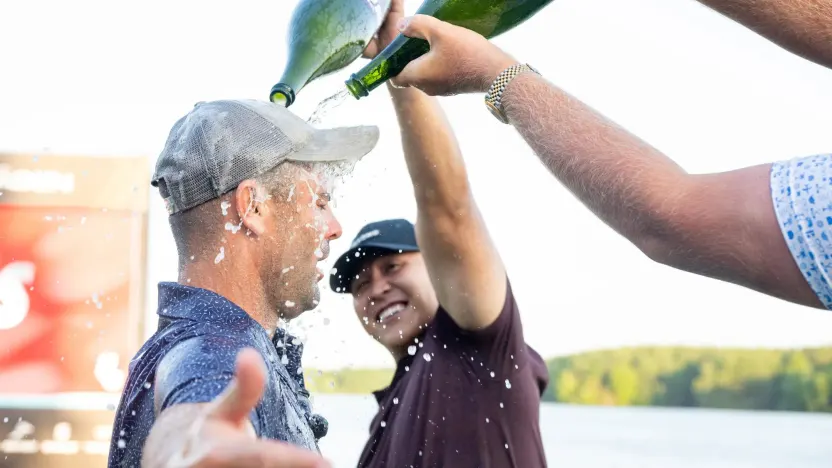 Announcer, Mason Nutt sprays champaign on content creator, Wesley Bryan on the 18th green after his win during the Duels Virginia before the start of LIV Golf Virginia at Robert Trent Jones Golf Club on Tuesday, June 03, 2025 in Gainesville, Virginia. (Photo by Charles Laberge/LIV Golf)