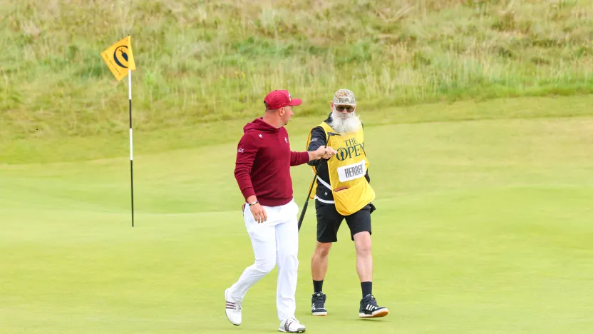 Lucas Herbert of Ripper GC and his caddie, Nick Pugh, fist bump on the seventh green during the first round of The Open Championship at Royal Portrush Golf Club on Thursday, July 17, 2025 in Portrush, Northern Ireland. (Photo by Chris Trotman/LIV Golf)