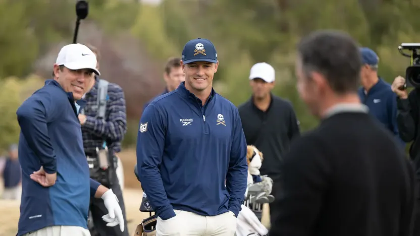 Captain Bryson DeChambeau of Crushers GC and Captain Brooks Koepka of Smash GC watch Rory McIlory on the driving range before the Showdown at the Shadow Creek Golf Course on Monday, Dec. 16, 2024 in Las Vegas, Nevada. (Photo by Montana Pritchard/LIV Golf)