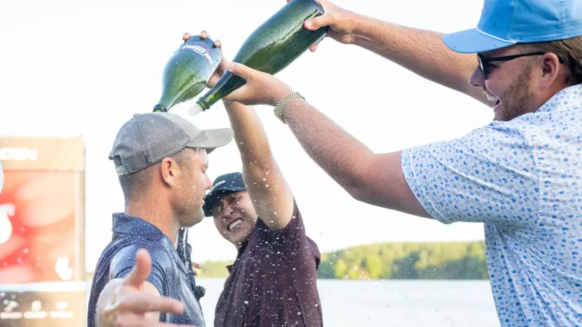 Announcer, Mason Nutt sprays champaign on content creator, Wesley Bryan on the 18th green after his win during the Duels Virginia before the start of LIV Golf Virginia at Robert Trent Jones Golf Club on Tuesday, June 03, 2025 in Gainesville, Virginia. (Photo by Charles Laberge/LIV Golf)