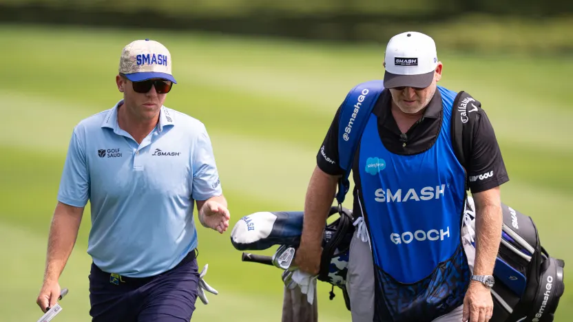 Talor Gooch of Smash GC and his caddie, Malcolm Baker, walk on the first hole during the first round of LIV Golf United Kingdom at JCB Golf & Country Club on Friday, July 25, 2025 in Rocester, England. (Photo by Pedro Salado/LIV Golf)