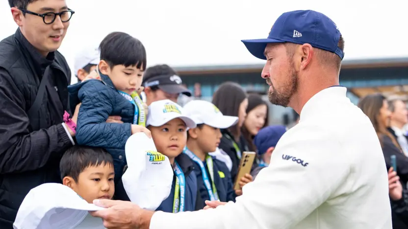 Captain Bryson DeChambeau of Crushers GC signs his autograph on the first tee during the second round of LIV Golf Korea at Jack Nicklaus Golf Club on Saturday, May 03, 2025 in Incheon, South Korea. (Photo by Pedro Salado/LIV Golf)