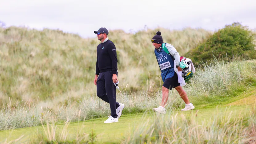 Dean Burmester of Stinger GC and his caddie, Jason Reynolds, walk on the seventh hole during the second round of The Open Championship at Royal Portrush Golf Club on Friday, July 18, 2025 in Portrush, Northern Ireland. (Photo by Chris Trotman/LIV Golf)