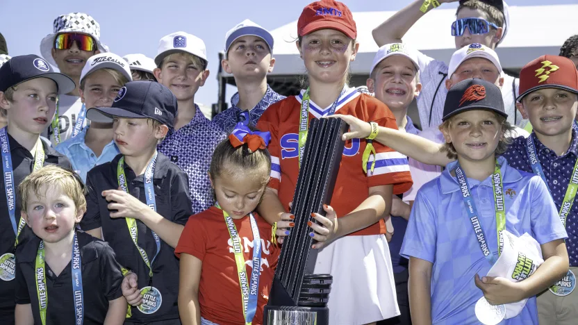 Little sharks pose for a photo with the First place individual championship trophy on the first tee during the first round of LIV Golf Dallas at Maridoe Golf Club on Friday, June 27, 2025 in Carrollton, Texas. (Photo by Charles Laberge/LIV Golf)