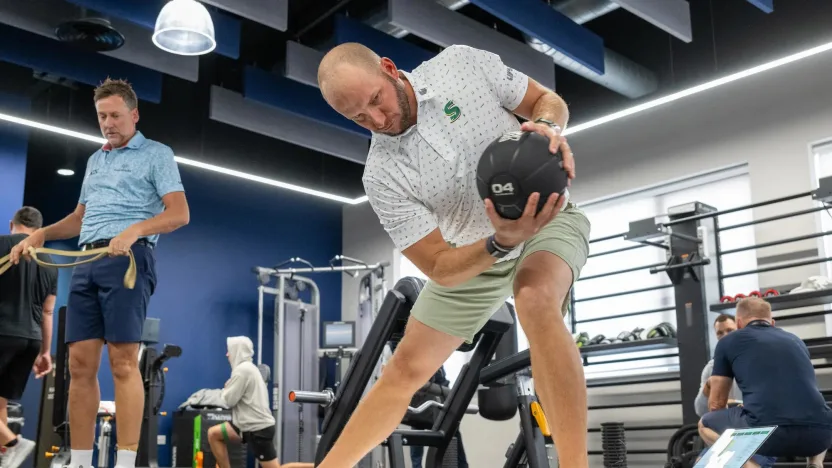 image: Dean Burmester of Stinger GC stretches in the gym before the second round of LIV Golf United Kingdom by JCB at JCB Golf & Country Club on Saturday, July 27, 2024 in Rocester, England. (Photo by Charles Laberge/LIV Golf)