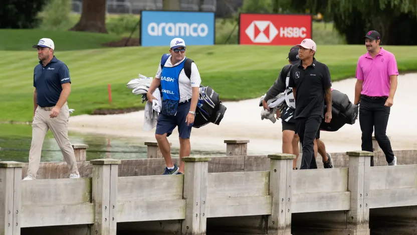 Graeme McDowell of Smash GC, caddie, Kenneth Comboy, Wild Card player, Anthony Kim and Peter Uihlein of RangeGoats GC walks the 18th hole bridge during the final round of LIV Golf United Kingdom at JCB Golf & Country Club on Sunday, July 27, 2025 in Rocester, England. (Photo by Matthew Harris/LIV Golf)