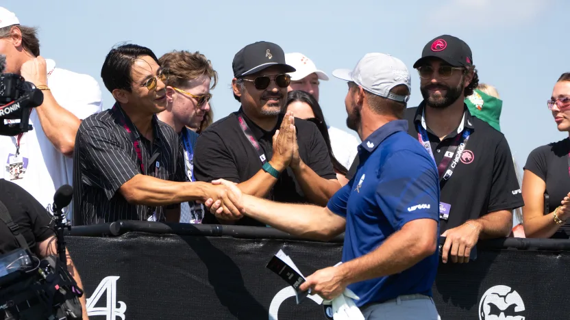 Captain Bryson DeChambeau of Crushers GC shakes hands with American Skateboarder, Sean Malto on the first tee during the first round of LIV Golf Chicago at Bolingbrook Golf Club on Friday, August 08, 2025 in Bolingbrook, Illinois. (Photo by Mike Stobe/LIV Golf)