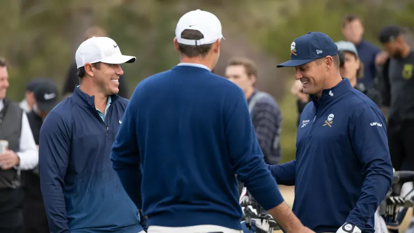 Captain Brooks Koepka of Smash GC and Captain Bryson DeChambeau of Crushers GC speak with Scottie Scheffler on the driving range before the Showdown at the Shadow Creek Golf Course on Monday, Dec. 16, 2024 in Las Vegas, Nevada. (Photo by Montana Pritchard/LIV Golf)