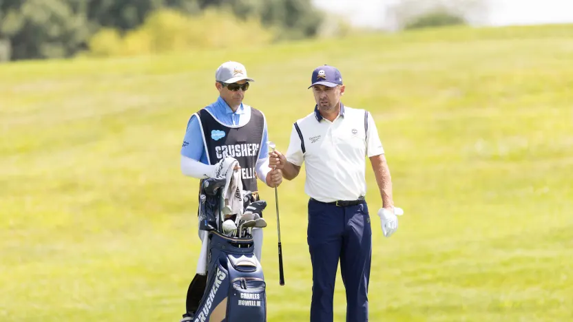 Charles Howell III of Crushers GC hand a club to caddie, Nick Jones on the 10th hole during the second round of LIV Golf Chicago at Bolingbrook Golf Club on Saturday, August 09, 2025 in Bolingbrook, Illinois. (Photo by Chris Trotman/LIV Golf)