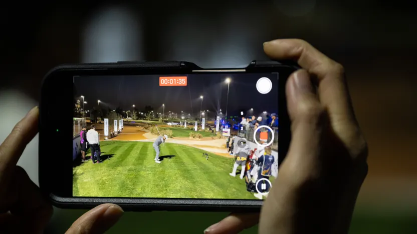 image: A fan records Paul Casey of Crushers GC off the seventh tee during the second round of LIV Golf Riyadh at Riyadh Golf Club on Friday, February 07, 2025 in Riyadh, Saudi Arabia. (Photo by Charles Laberge/LIV Golf)