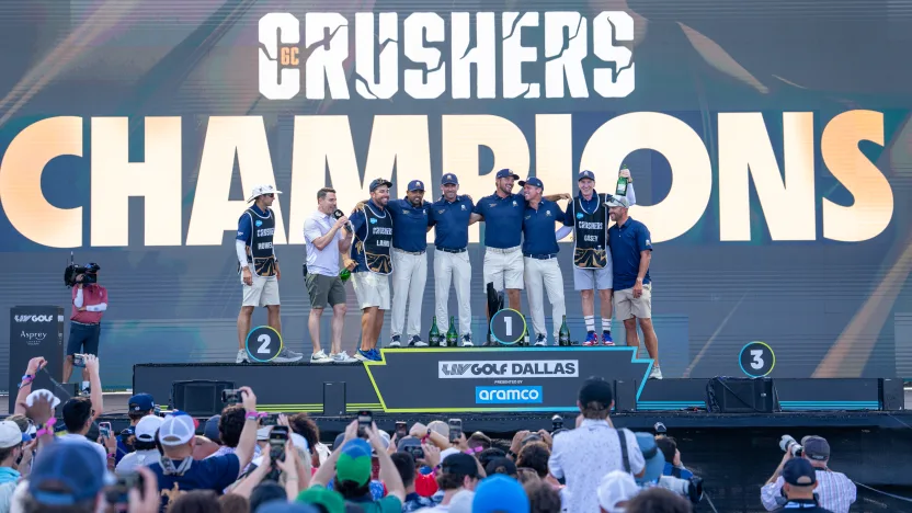 Captain Bryson DeChambeau of Crushers GC, Anirban Lahiri of Crushers GC Charles Howell III of Crushers GC, Paul Casey of Crushers GC caddie, John McLaren, caddie, Greg Bodine, Anirban Lahiri of Crushers GCc/ and caddie, Nick Jones,celebrate winning First place team champions on stage following the final round of LIV Golf Dallas at Maridoe Golf Club on Sunday, June 29, 2025 in Carrollton, Texas. (Photo by LIV Golf)