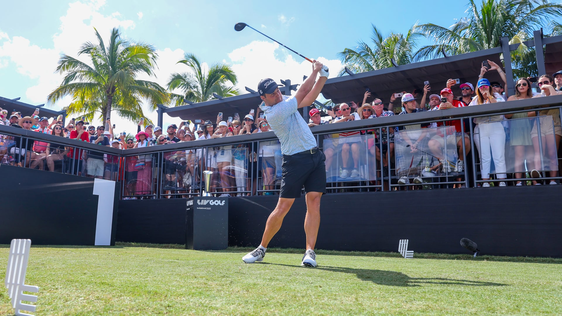 image: Peter Uihlein tees off in front of a crowd