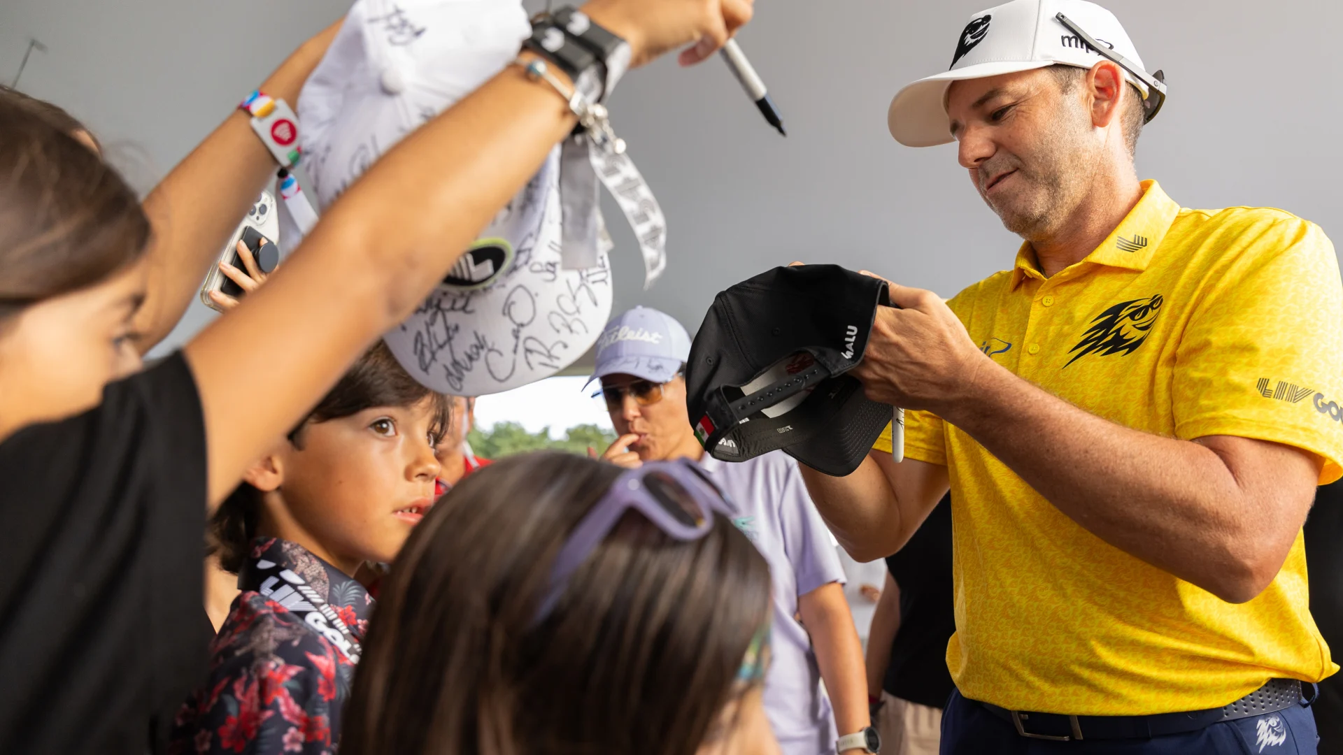 Sergio signs autographs for kids
